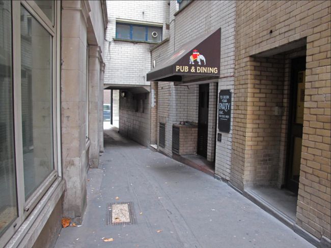 In 2013, taken in Hogarth Court, this is the side entrance to the 1957 rebuilt pub. This building was demolished in 2015. The office block Fen Court now stands on this site.