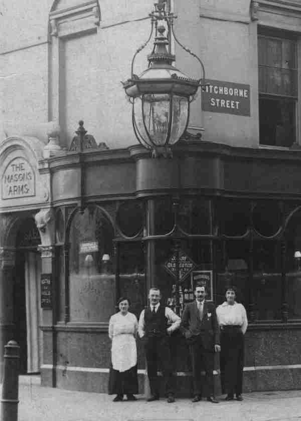 Masons Arms taken in about 1915. I have been told that my Grandparents Herbert Stapley and Sarah Penney worked in the kitchen there as a Kitchen Clerk and Sauce Chef. They are the couple  on the left in the picture.  I think that the pub was probably destroyed during a bombing raid in 1941. **